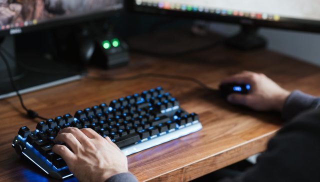 crop unrecognizable man working on modern computer