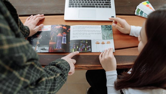 man and woman discussing about the brochure information