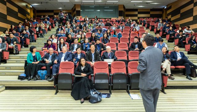 man standing in front of people
