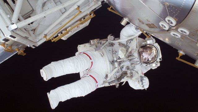 person in white astronaut suit